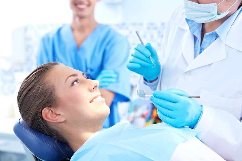Woman having checkup at dental surgery